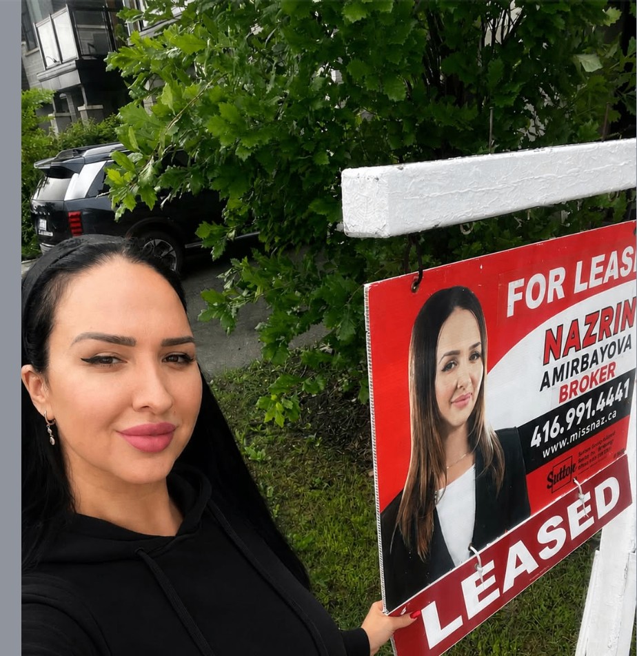 Nazrin beside a leased sign in front of a Thornhill townhouse